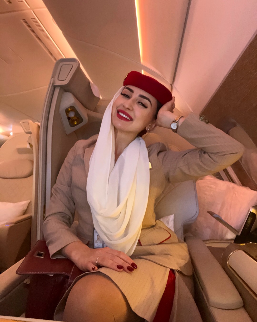 Weronika in her Emirates cabin crew uniform on board an aircraft